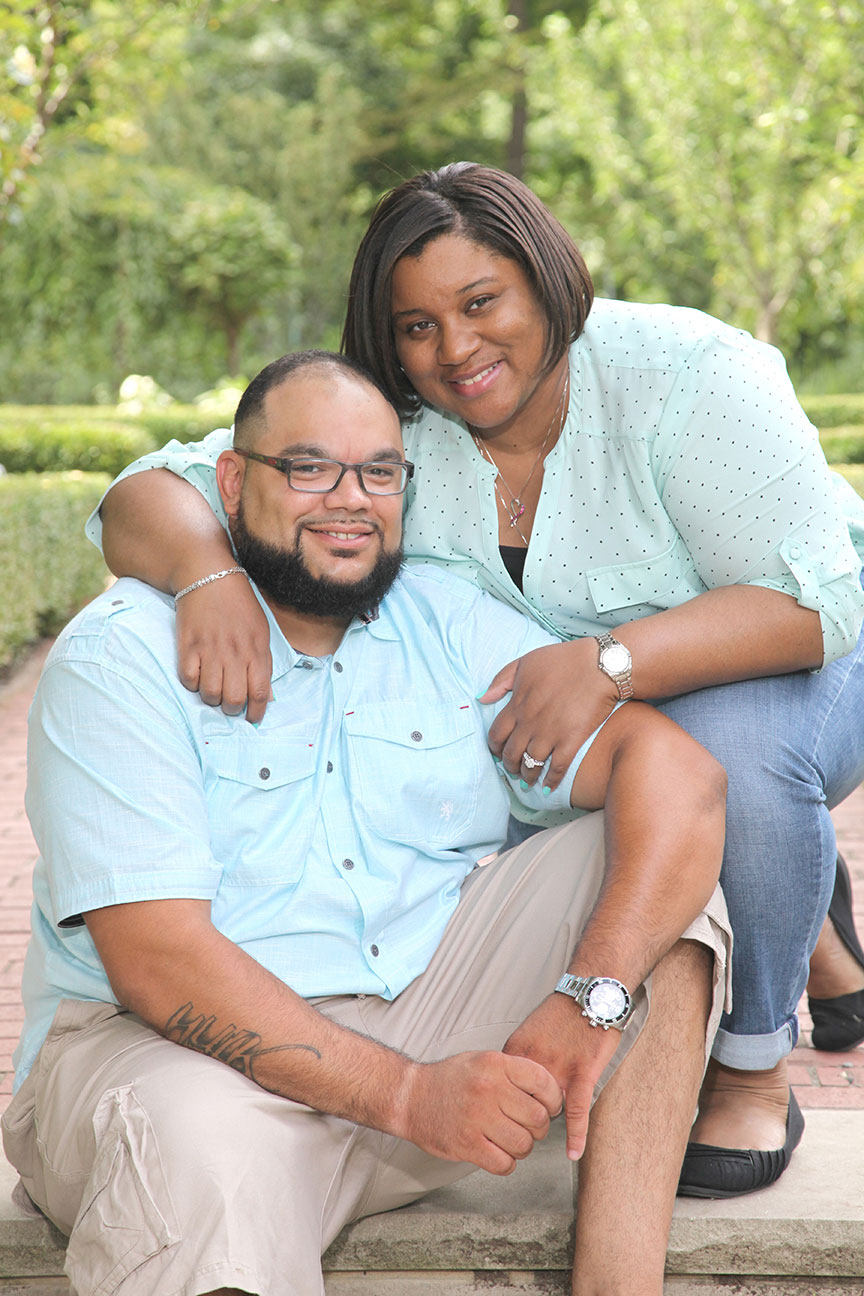african-american couple posing for a picture on the steps at the park