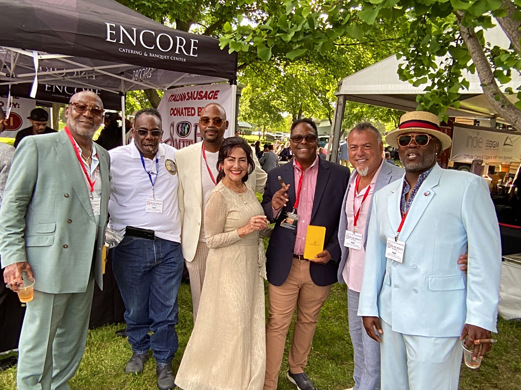 Cigar Queen Cynthia Fuente posing for photo at Smoke the D, Cars and Cigars benefit in Detroit