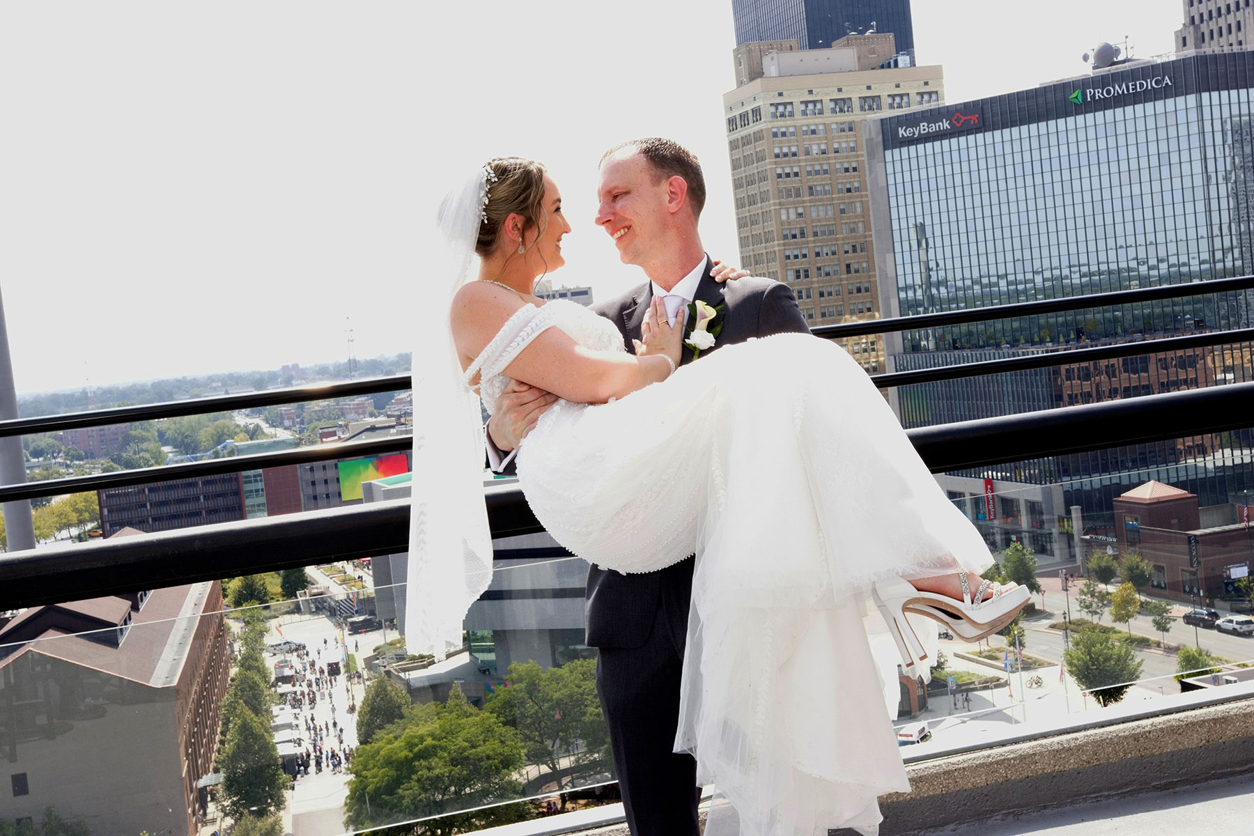  downtown Toledo Ohio wedding couple posing atop the Renassance Hotel balcony