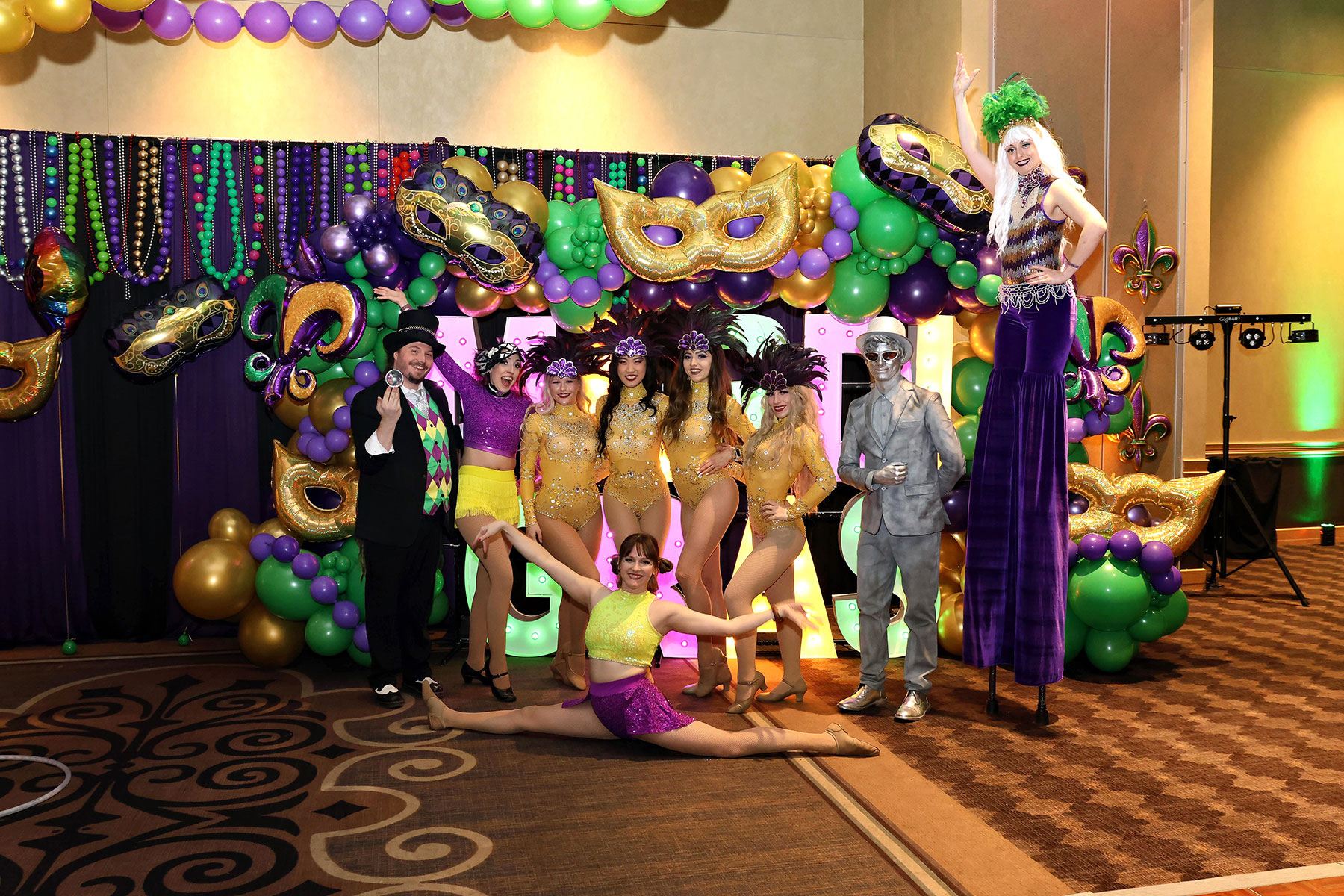 Mardi Gras themed holiday party photo with Glovation Circus performers 