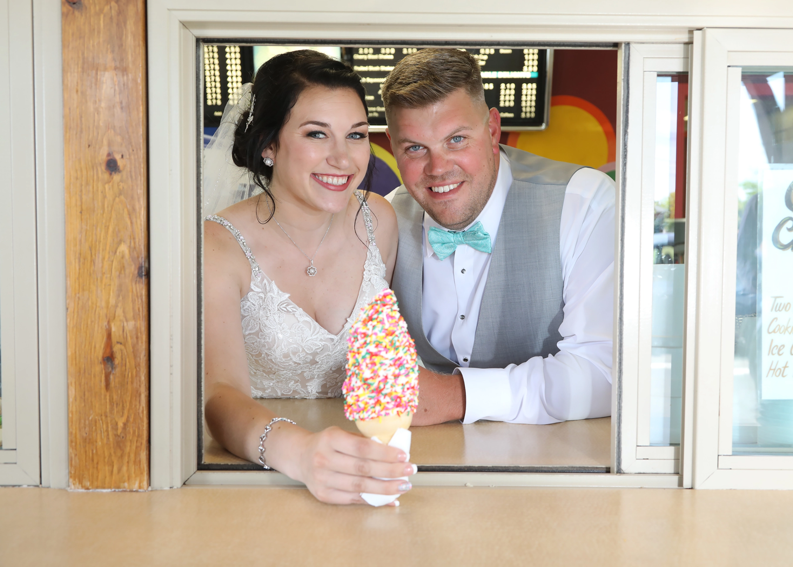 happy couple serving an ice cream cone covered in sprinkles from Mr. Freeze in Perrysburg, Ohio