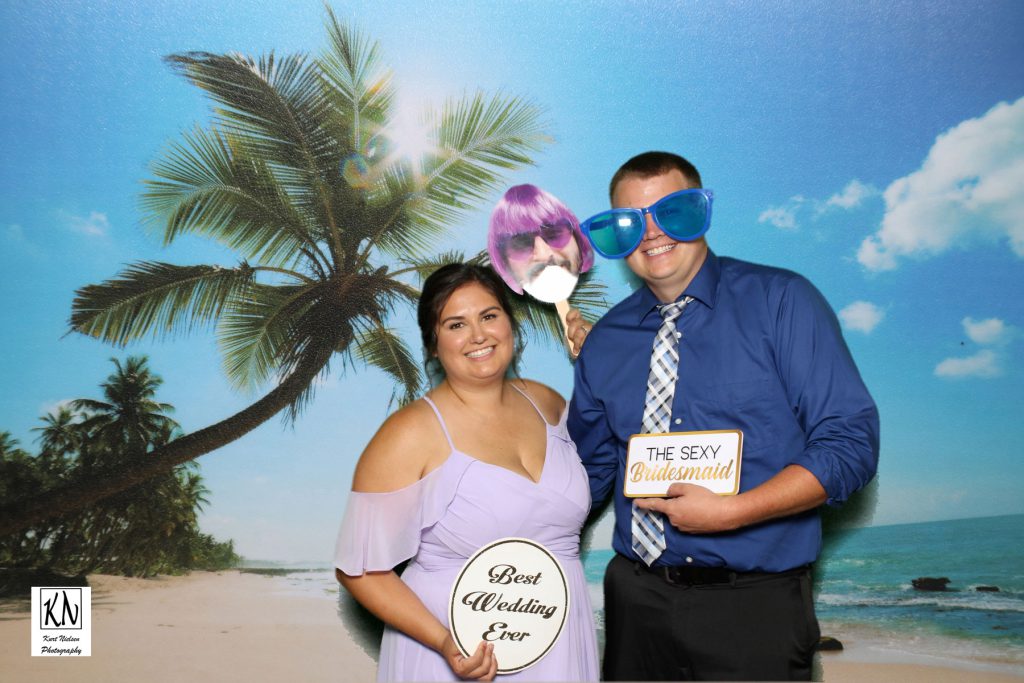 former bride and groom posing for a photo in Kurt Nielsen's original green screen photo booth