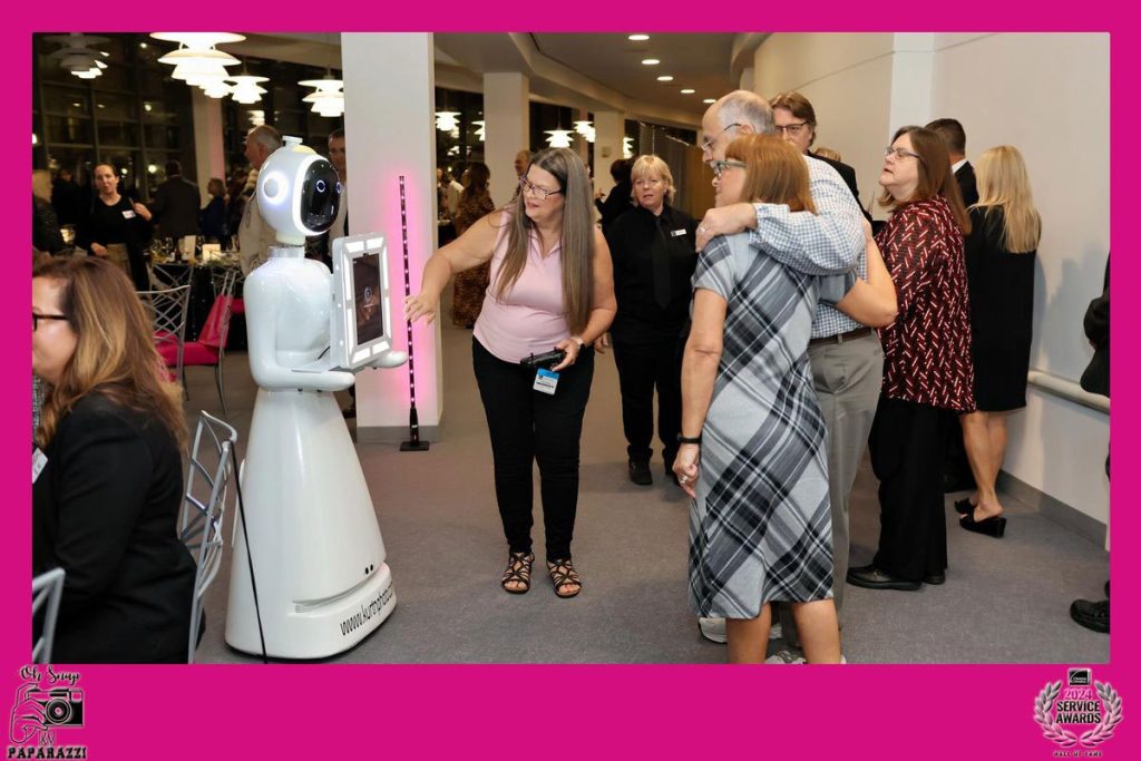 Rosie the Robot AI photo booth is taking a photo of a group of guests at the Owens Corning Service Awards dinner at their headquarters in downtown Toledo