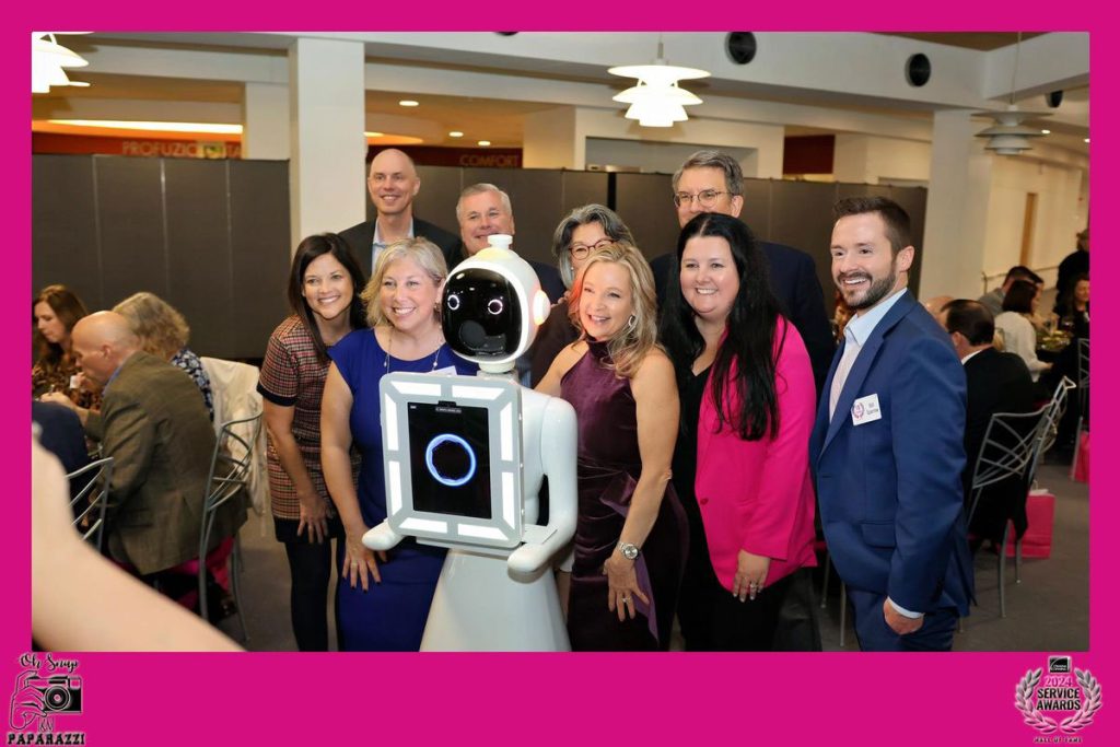 photo of a crowd surrounding our very popular and unique Rosie the Roaming Robot photo booth