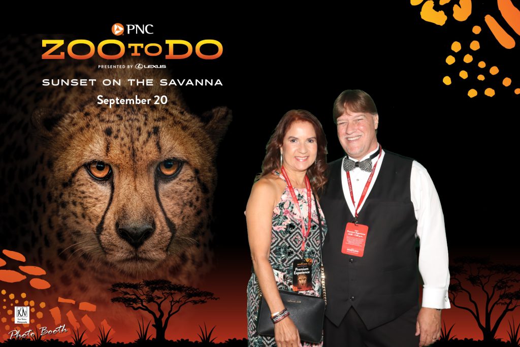 Peter Boyer and wife pose for a photo at the VIP photo experience inside the Malawi Center at the Toledo Zoo to Do