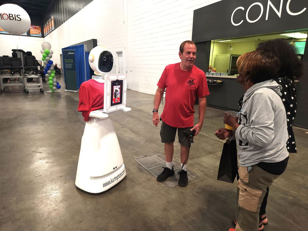 Rosie the Robot taking a photo of a couple at JeepFest inside the Glass City Center in downtown Toledo