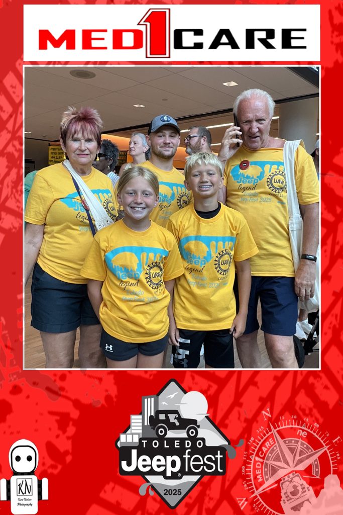 Bruce Baumhower and family posing for a photo from Rosie the AI robot photo booth at JeepFest