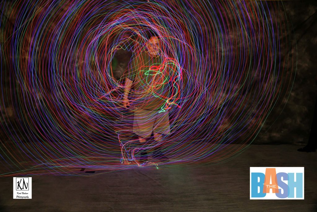 imagination station employee practicing light techniques in the  light painting photo booth at the Imagination Station Bash by Kurt Nielsen Photography
