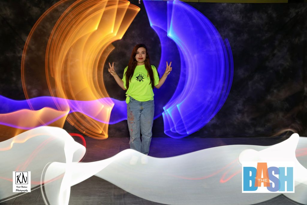 employee from spin and spat posing in my light painting photo booth at the Imagination Station Bash by Kurt Nielsen Photography