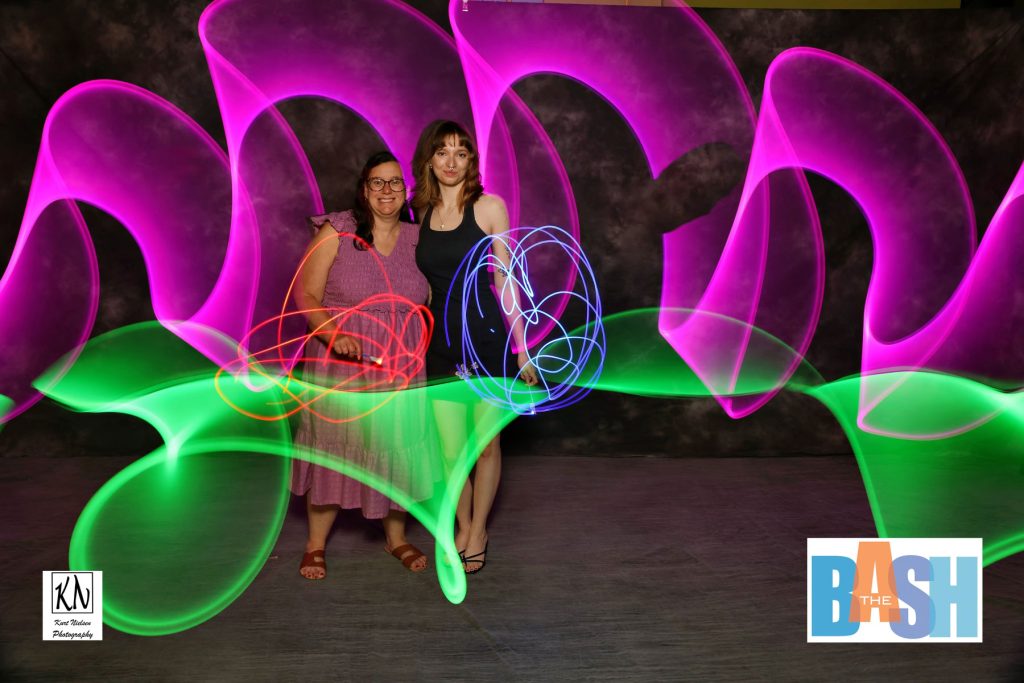 two girls posing in my light painting photo booth at the Imagination Station Bash by Kurt Nielsen Photography