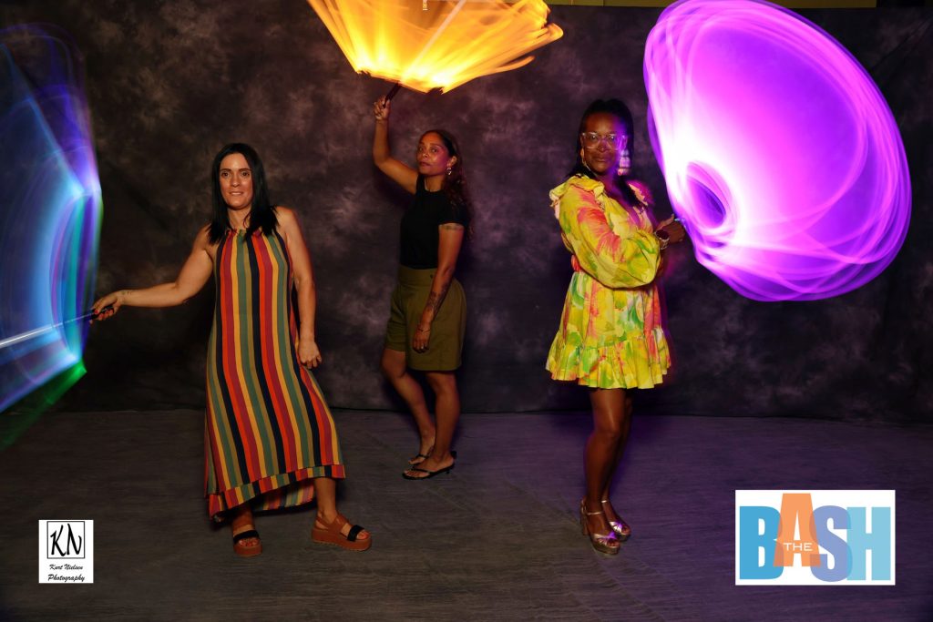 Rebecca Bennett, Shana Lee, and Angela Lucas having fun in the light painting photo booth at the Imagination Station Bash by Kurt Nielsen Photography