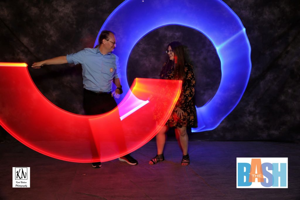 Josh Croup from 13 abc having fun with light sabers in the light painting photo booth at the Imagination Station Bash by Kurt Nielsen Photography