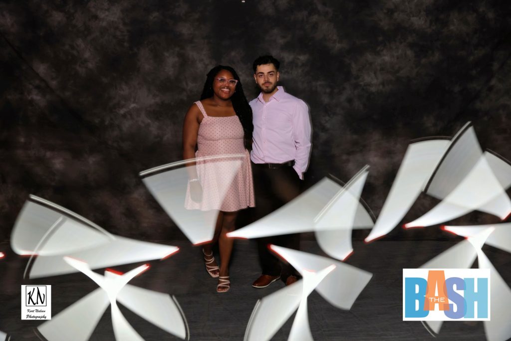 couple posing for a light painting photo booth at the Imagination Station Bash by Kurt Nielsen Photography using a white light source