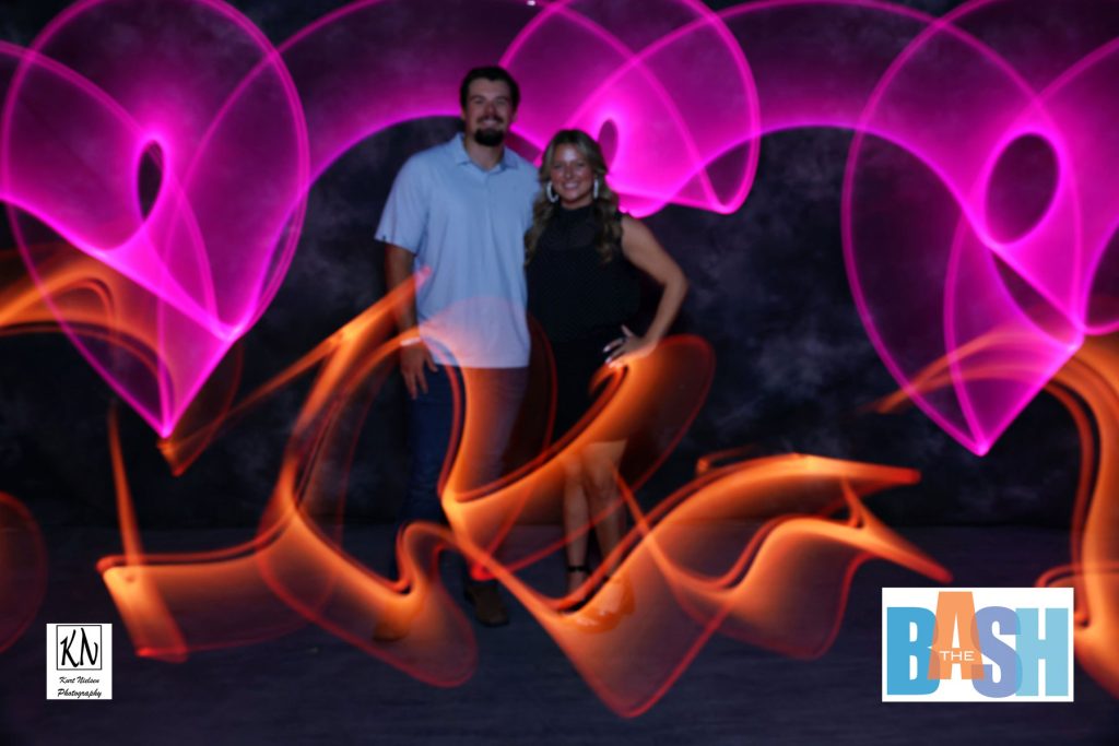 a couple posing for the camera in the light painting photo booth at the Imagination Station Bash by Kurt Nielsen Photography