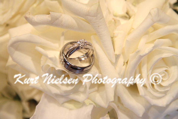 wedding rings on white roses