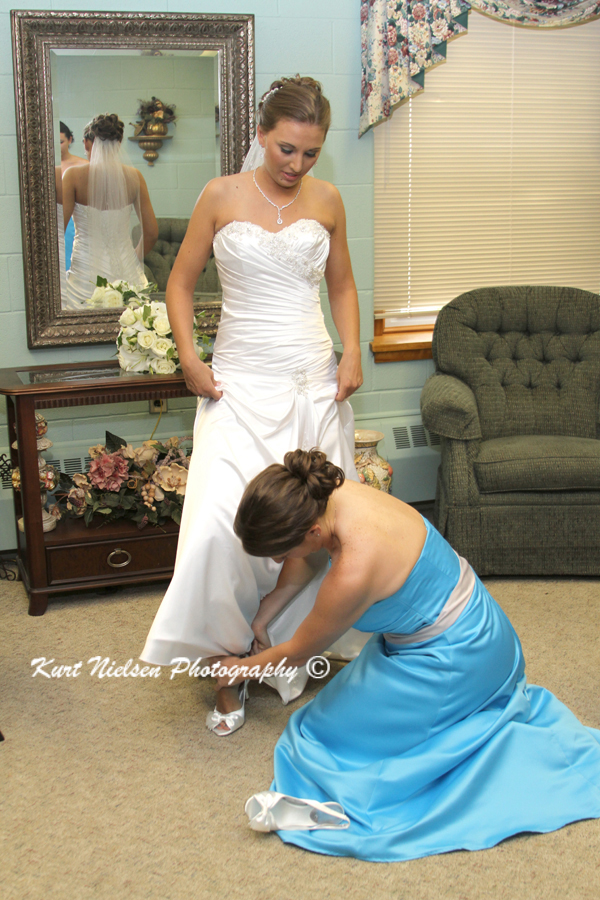 putting on wedding shoes