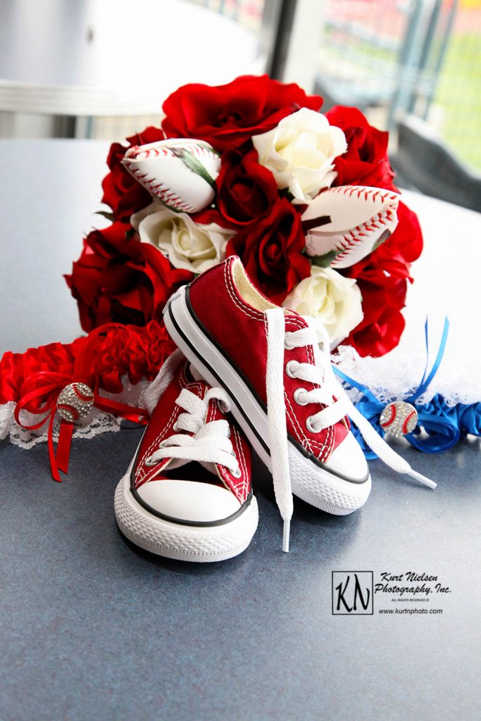 red converse wedding shoes with artificial rose and baseball roses bouquet