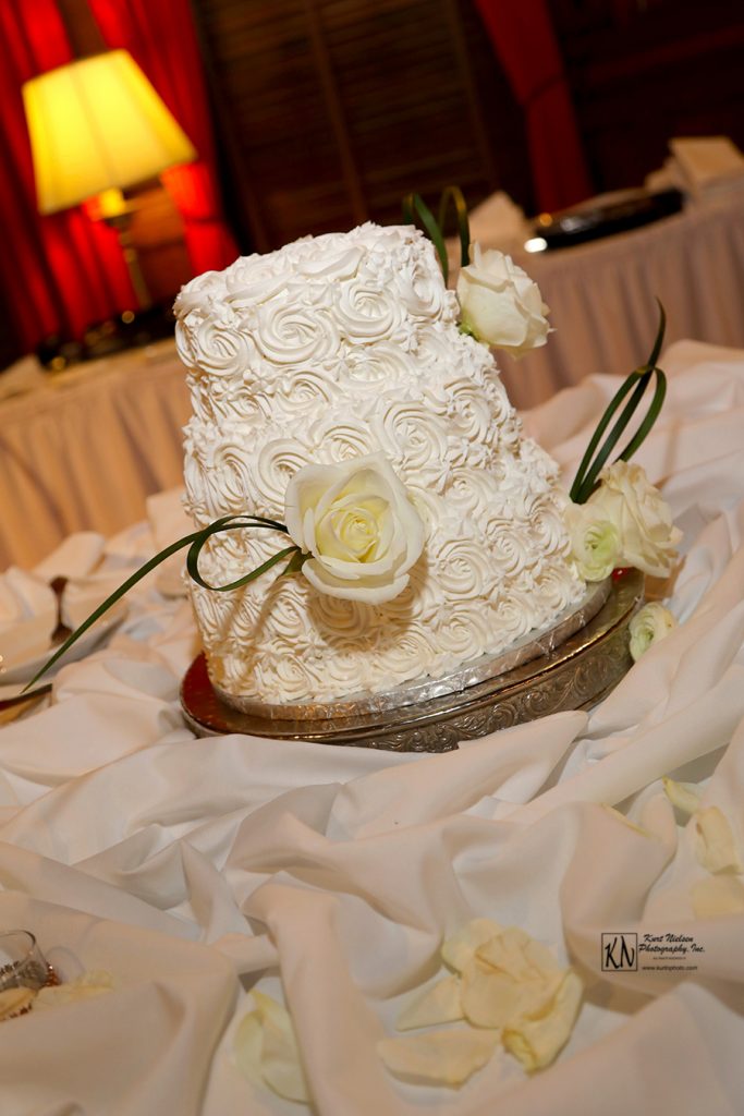 white wedding cake with icing roses