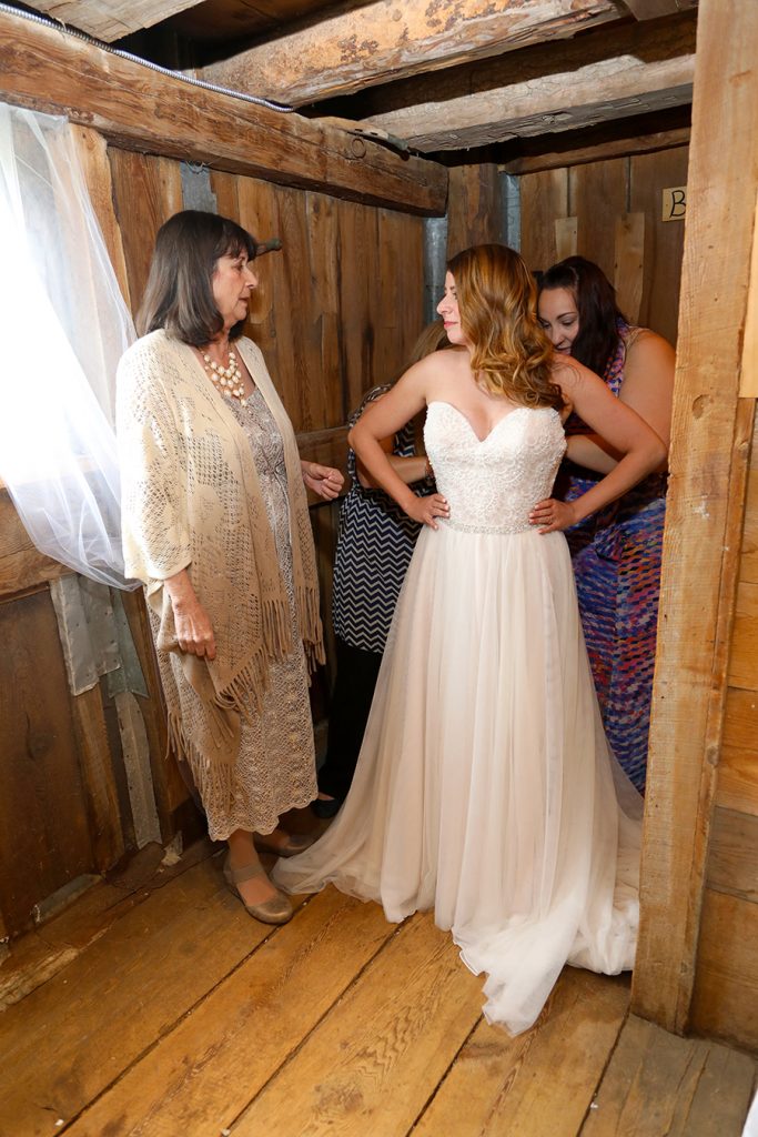 helping the bride get into her gown photos