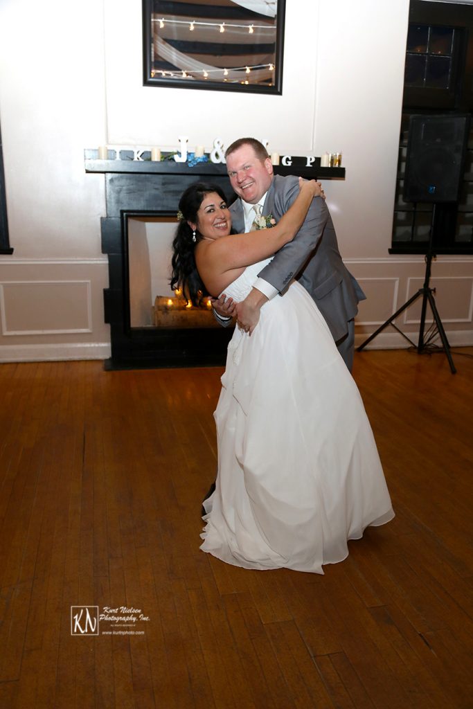 groom dipping the bride