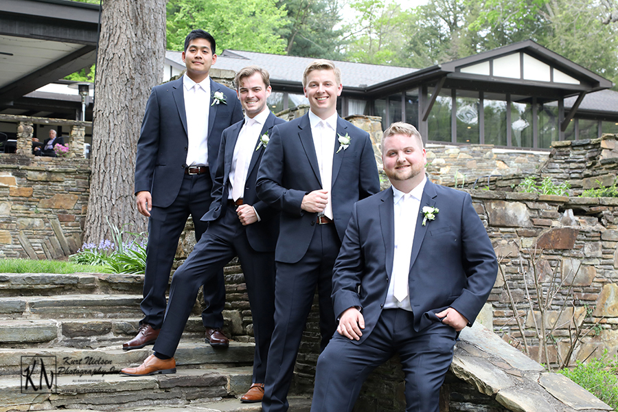 casual poses of the groom and his groomsmen