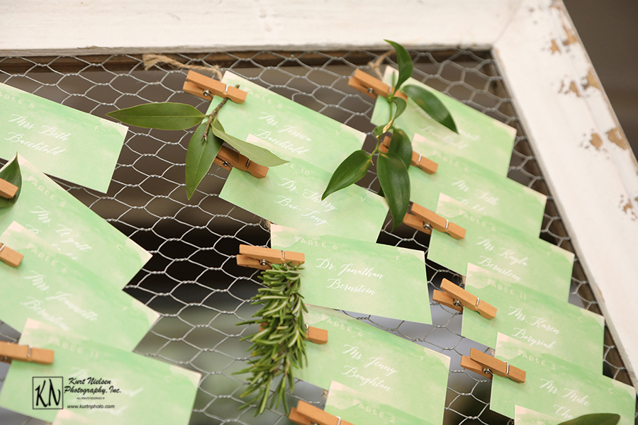 leafy green seating cards with white lettering from minted