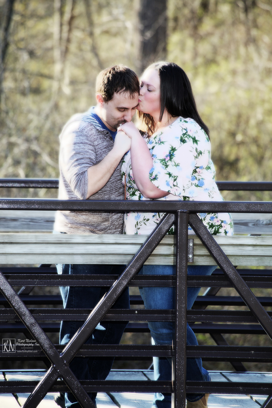 romantic spring engagement photo on a bridge
