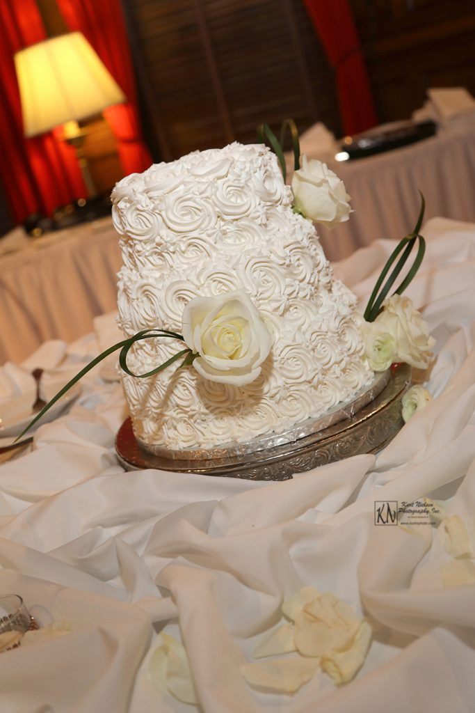 three layer white wedding cake with rosette frosting