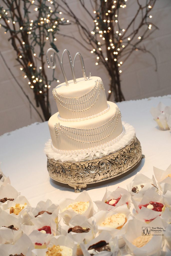 2 tier fondant covered wedding cake with scalloped silver bead garland from Michael's Cafe and Bakery