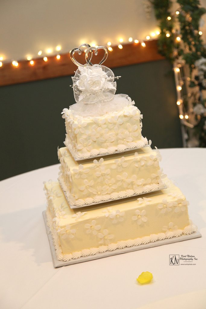 fondant covered square wedding cake with gum paste flowers