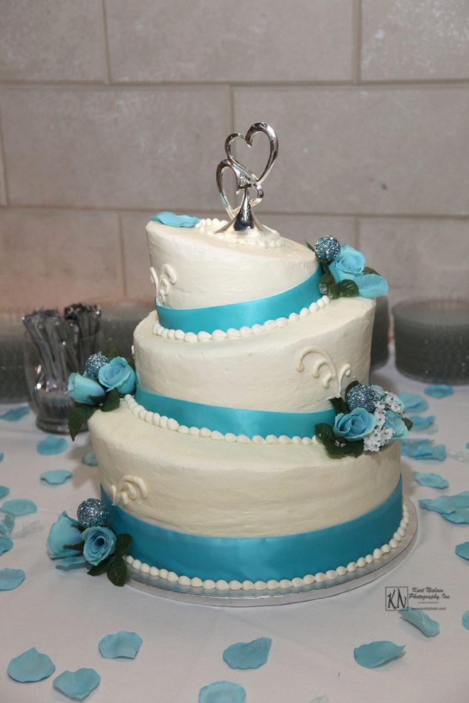 caribbean blue flowers on tilted wedding cake